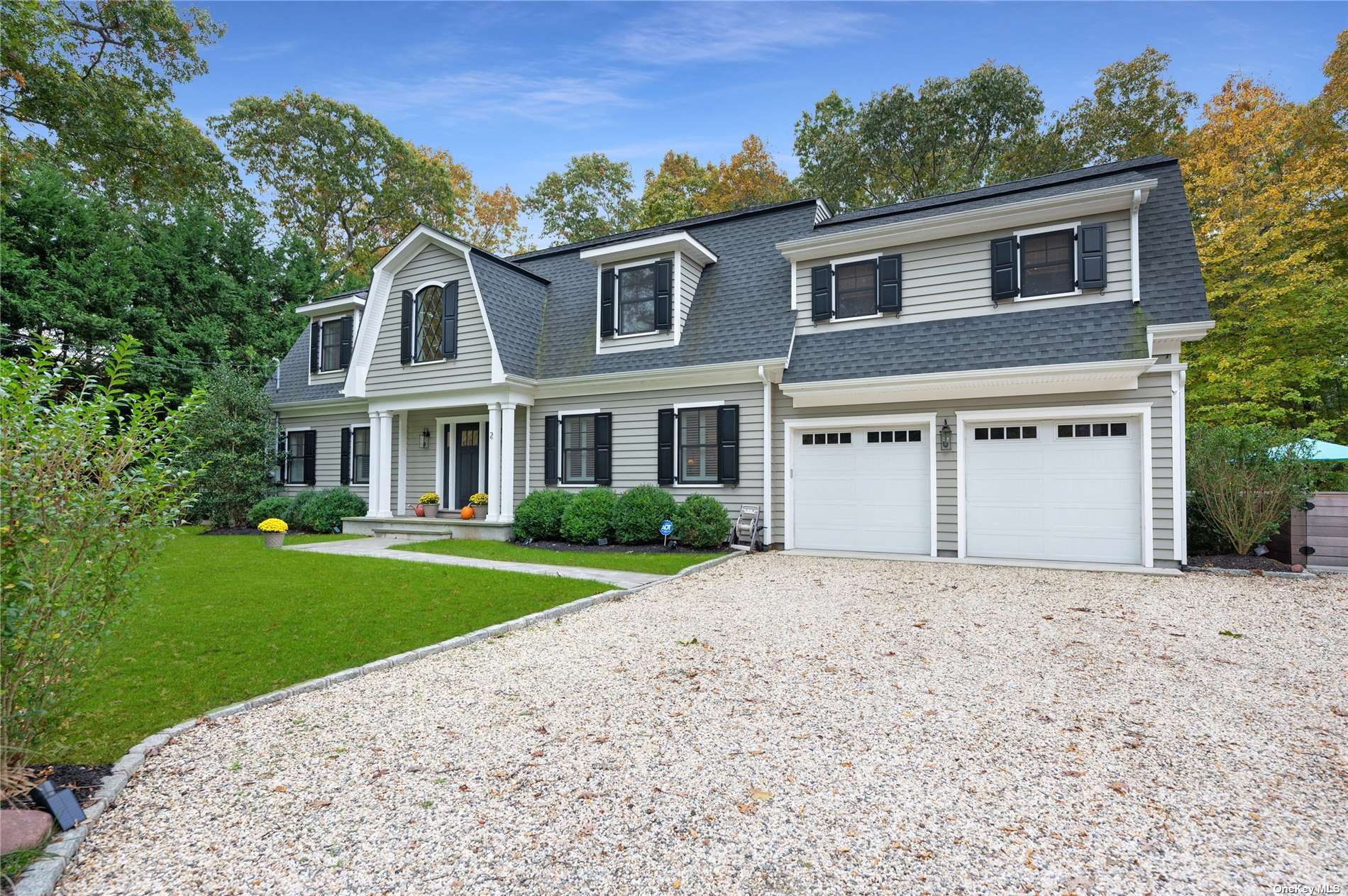 2 Roses Grove Road Southampton, NY 11968 - Photo 1 of 1 a front view of a house with a yard and garage