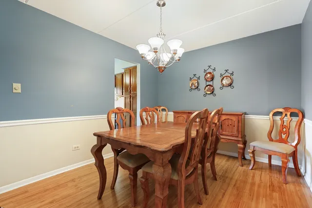 a view of a dining room with furniture wooden floor and a chandelier