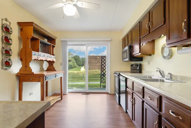 a kitchen with stainless steel appliances granite countertop a stove a sink and a refrigerator