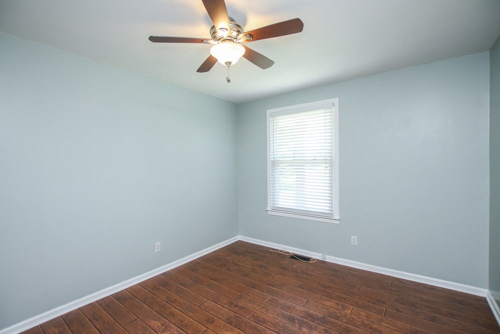 590 Weeping Elm Road Mount Juliet, TN 37122 - Photo 15 of 20 an empty room with wooden floor fan and windows