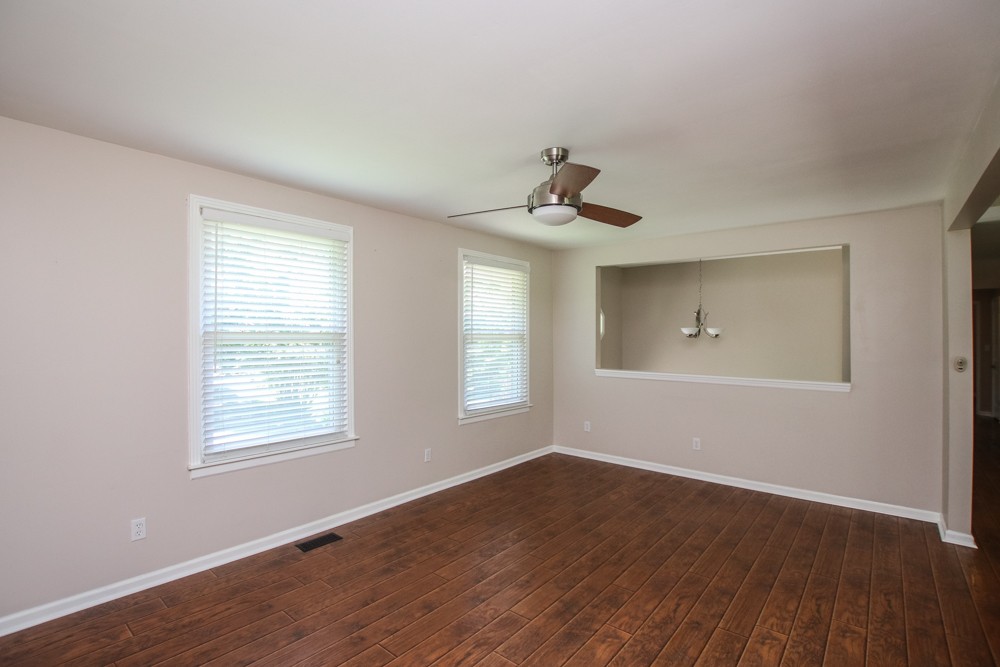 590 Weeping Elm Road Mount Juliet, TN 37122 - Photo 3 of 20 a view of an empty room with wooden floor and a window