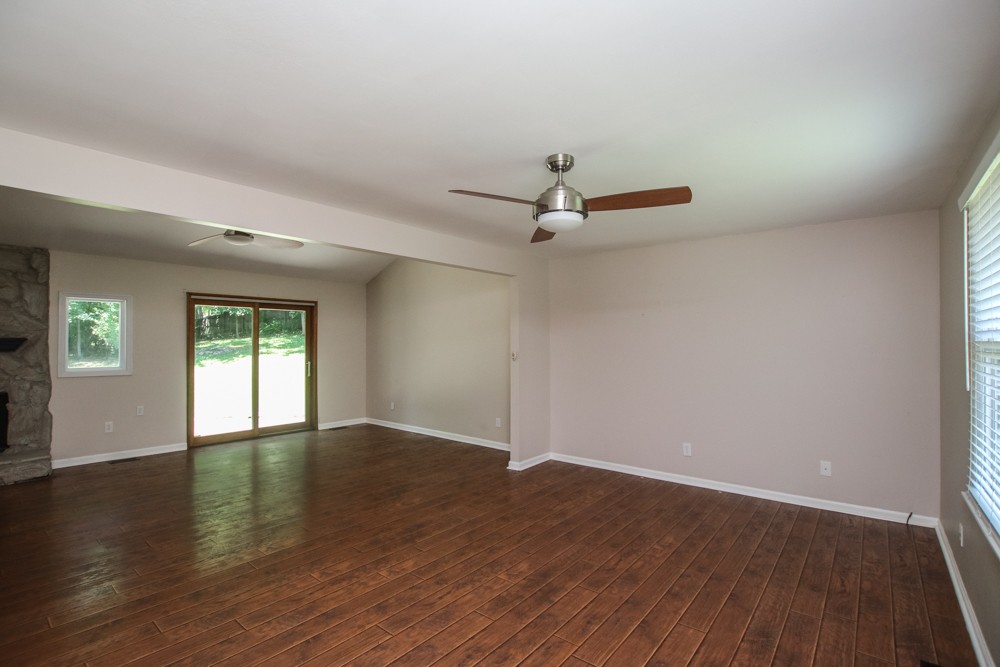 590 Weeping Elm Road Mount Juliet, TN 37122 - Photo 4 of 20 an empty room with wooden floor ceiling fan and windows