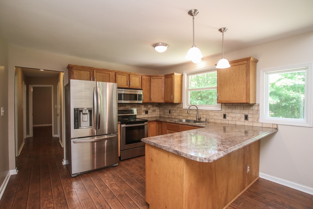 590 Weeping Elm Road Mount Juliet, TN 37122 - Photo 6 of 20 a kitchen with a refrigerator a sink and wooden floor