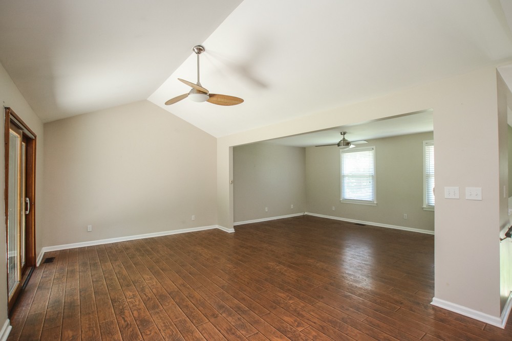 590 Weeping Elm Road Mount Juliet, TN 37122 - Photo 8 of 20 an empty room with wooden floor and windows