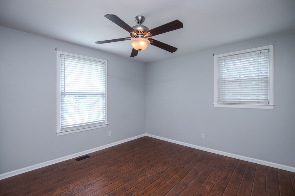 590 Weeping Elm Road Mount Juliet, TN 37122 - Photo 9 of 20 a view of an empty room with wooden floor and a window