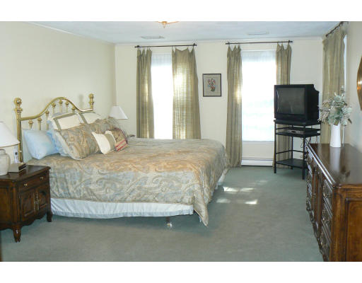 54 Ridge Avenue Newton, MA 02459 - Photo 11 of 20 a bedroom with a bed and flat tv screen on the dresser