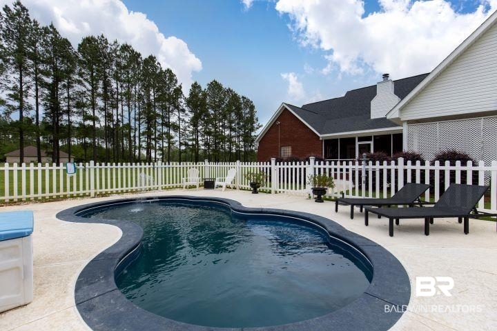 24541 Baldwin Beach Expressway Robertsdale, AL 36567 - Photo 35 of 51 View of pool with a fenced backyard, a fenced in pool, and a patio