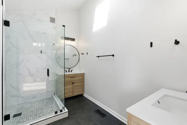 a bathroom with a sink mirror and vanity