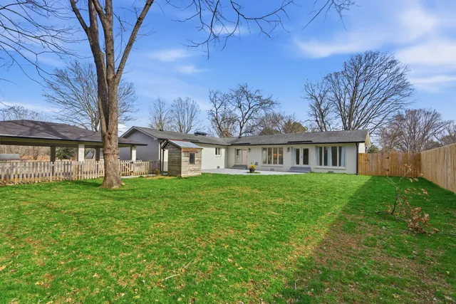 an aerial view of a house with a yard basket ball court and outdoor seating