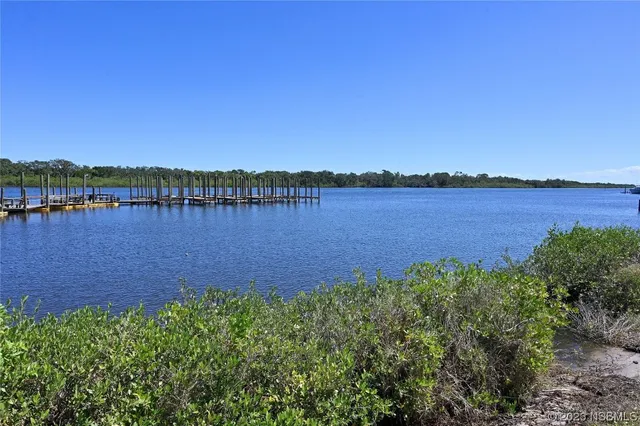 a view of a lake with houses in the back