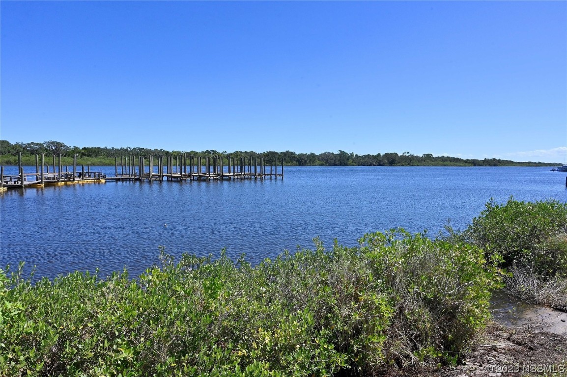 4339 Cedar Way Edgewater, FL 32141 - Photo 12 of 16 a view of a lake with houses in the back