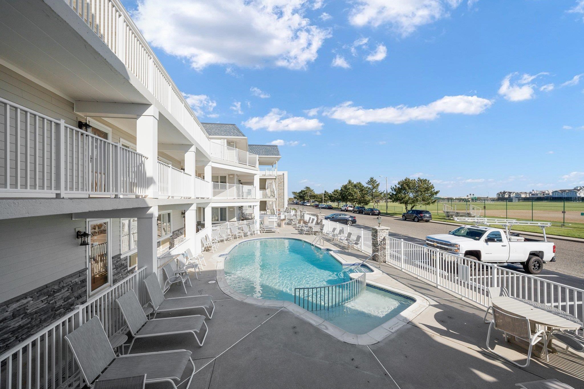 177 80th Street, Unit 304 Avalon, NJ 08202 - Photo 12 of 31 a view of a swimming pool with seating space