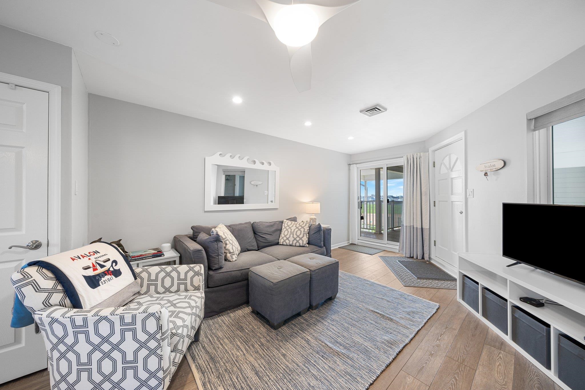 177 80th Street, Unit 304 Avalon, NJ 08202 - Photo 18 of 31 a living room with furniture and a flat screen tv