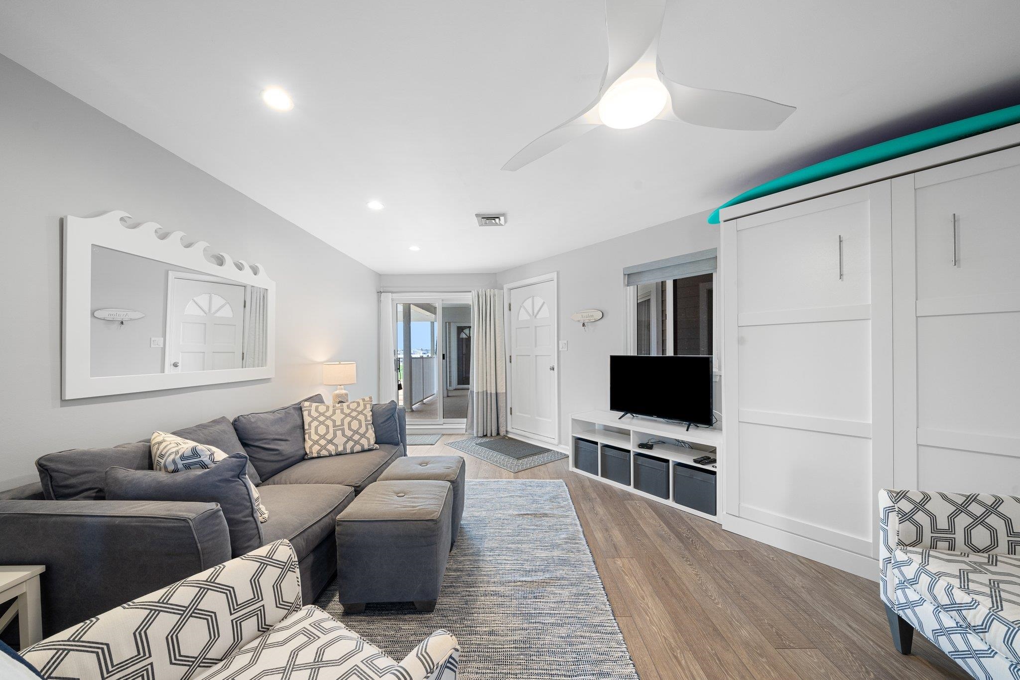 177 80th Street, Unit 304 Avalon, NJ 08202 - Photo 19 of 31 a living room with furniture and a flat screen tv