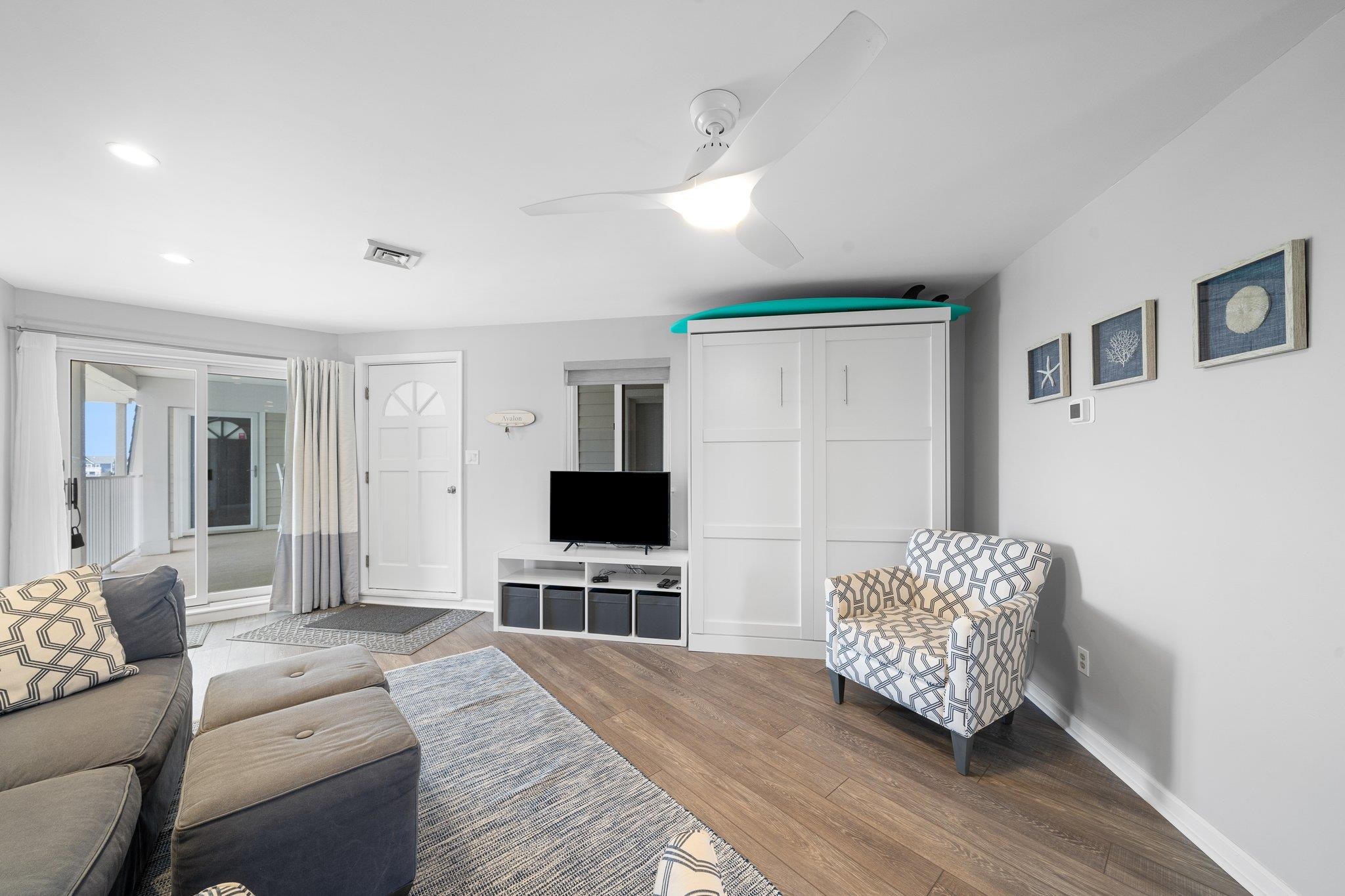 177 80th Street, Unit 304 Avalon, NJ 08202 - Photo 20 of 31 a living room with furniture and a flat screen tv