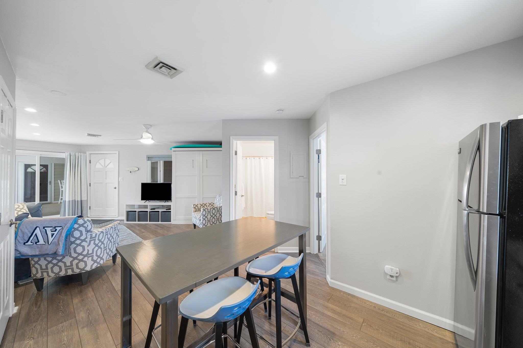 177 80th Street, Unit 304 Avalon, NJ 08202 - Photo 2 of 31 a view of a dining room with furniture and wooden floor