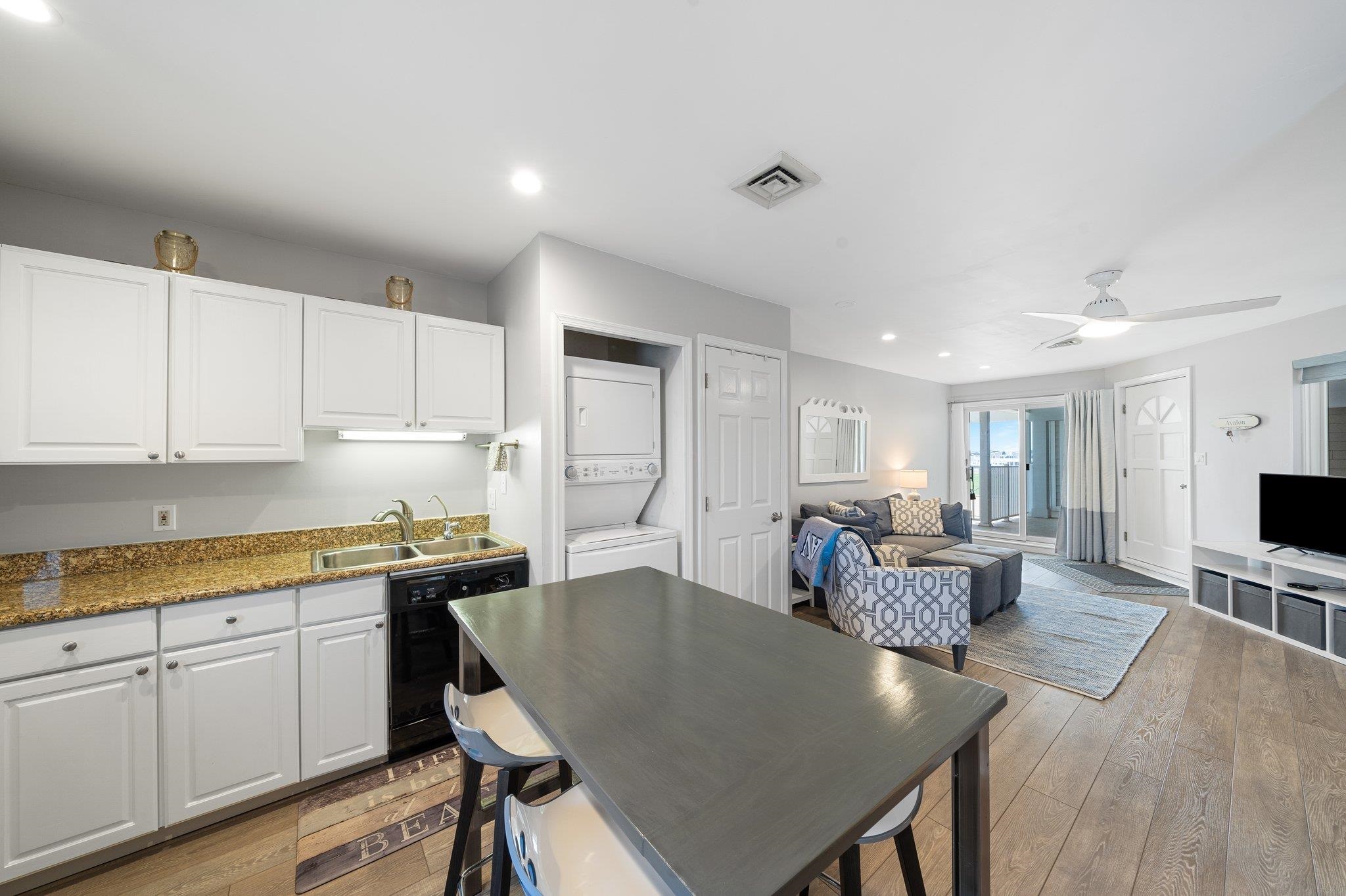 177 80th Street, Unit 304 Avalon, NJ 08202 - Photo 3 of 31 a large kitchen with kitchen island a island a sink a stove and a center island