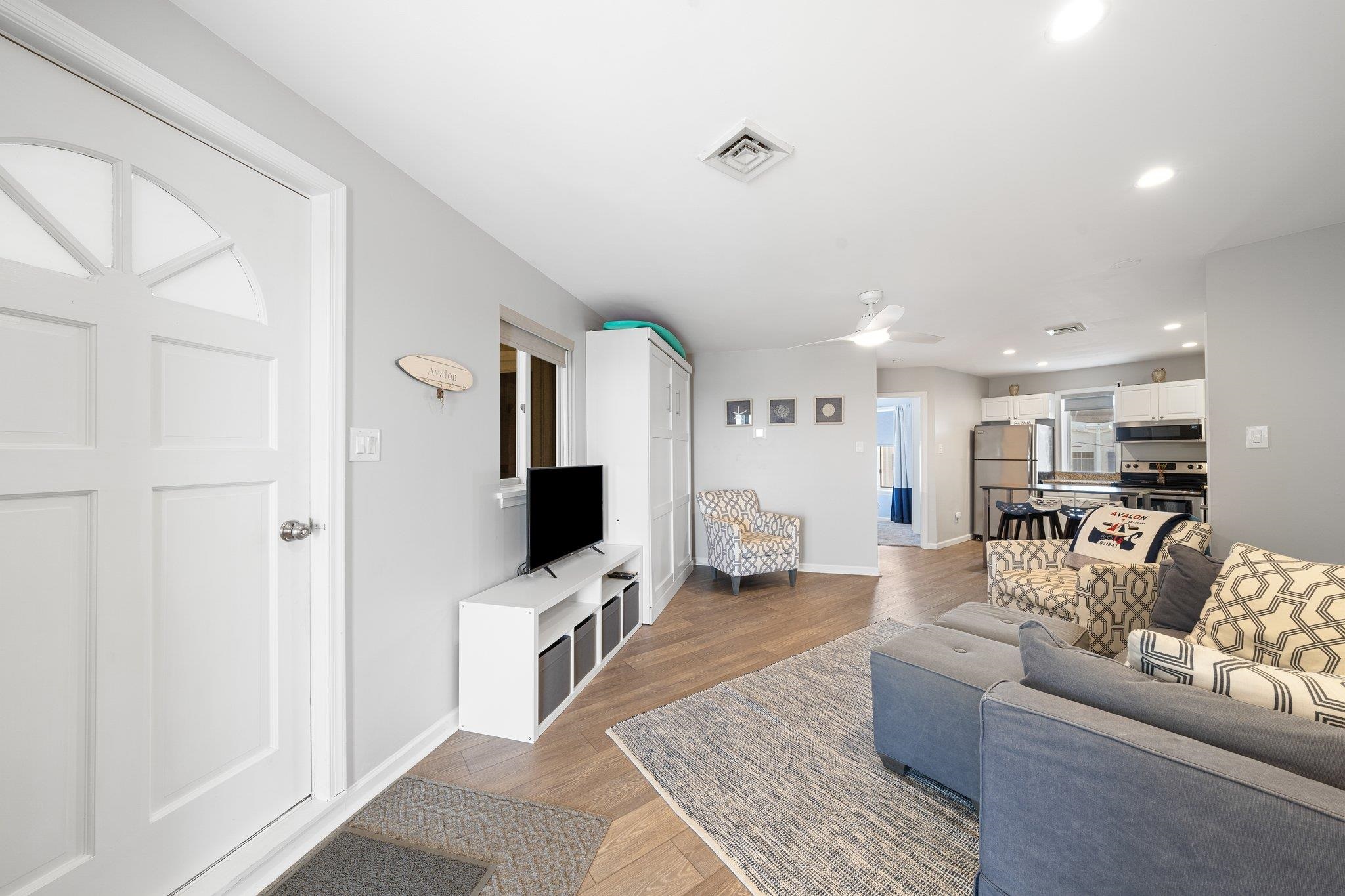 177 80th Street, Unit 304 Avalon, NJ 08202 - Photo 31 of 31 a living room with furniture and a flat screen tv