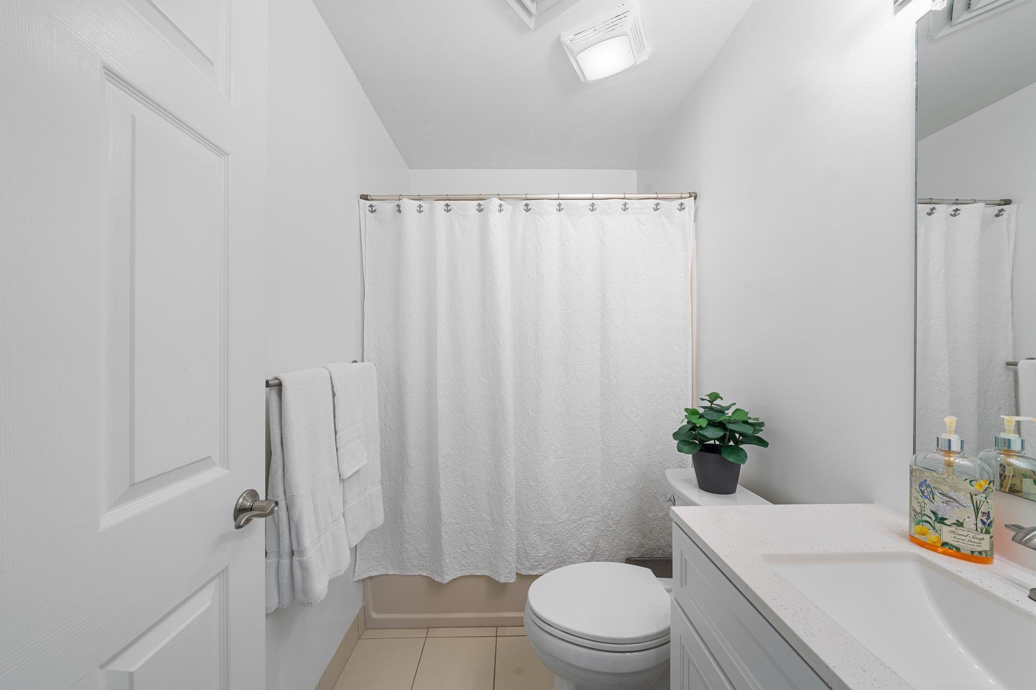 177 80th Street, Unit 304 Avalon, NJ 08202 - Photo 6 of 31 a bath room with a toilet a sink and a tub