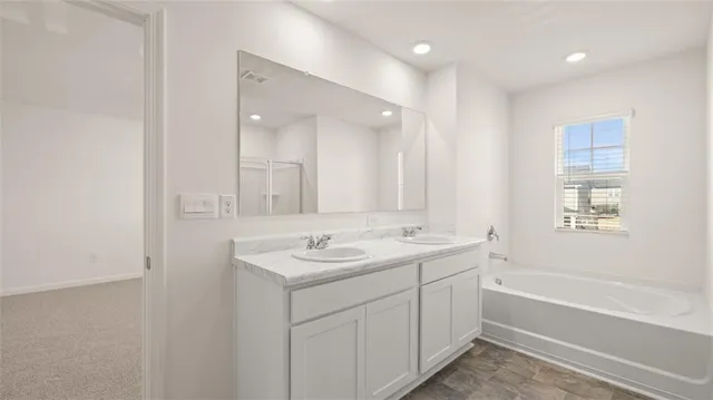 a bathroom with 2 sink tub and a mirror