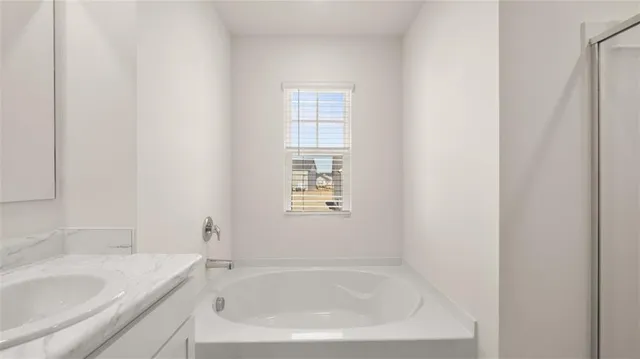 a white bath tub sitting next to a white sink