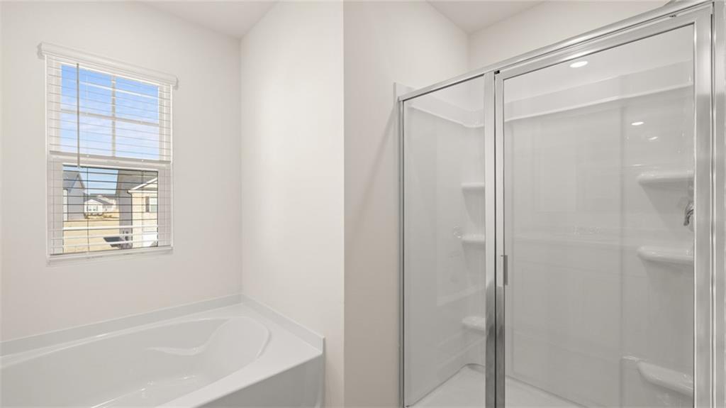 73 White Spruce Way Newnan, GA 30265 - Photo 27 of 47 a bathroom with a bathtub and a shower