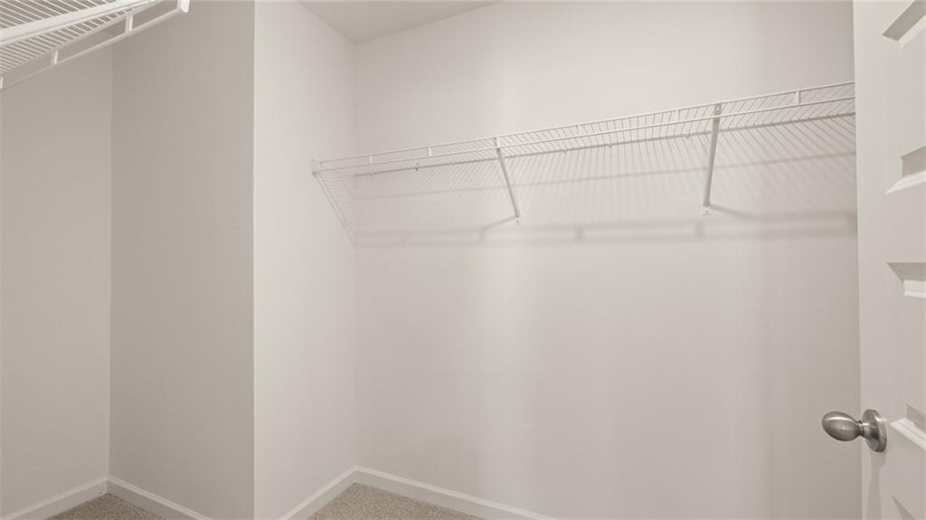 73 White Spruce Way Newnan, GA 30265 - Photo 28 of 47 a view of a room with racks on the wall