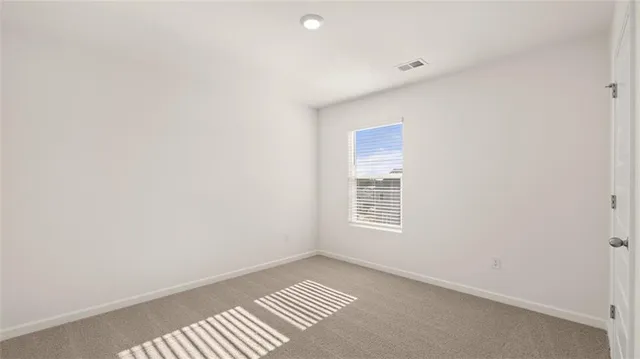 a view of an empty room and a window