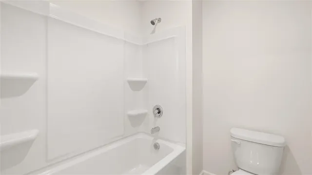a white bath tub sitting next to a white toilet