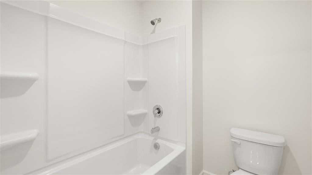 73 White Spruce Way Newnan, GA 30265 - Photo 40 of 47 a white bath tub sitting next to a white toilet