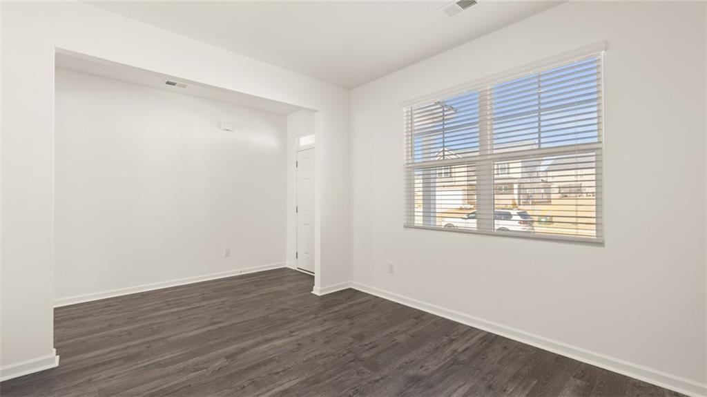 73 White Spruce Way Newnan, GA 30265 - Photo 5 of 47 a view of an empty room with wooden floor and a window