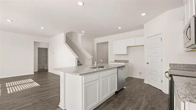 a kitchen with a sink stove and cabinets