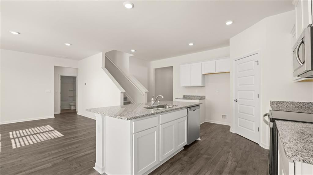 73 White Spruce Way Newnan, GA 30265 - Photo 10 of 47 a kitchen with a sink stove and cabinets