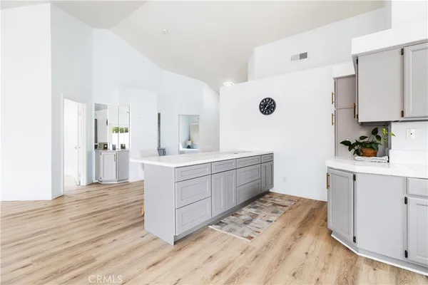 a kitchen with a sink cabinets and wooden floor