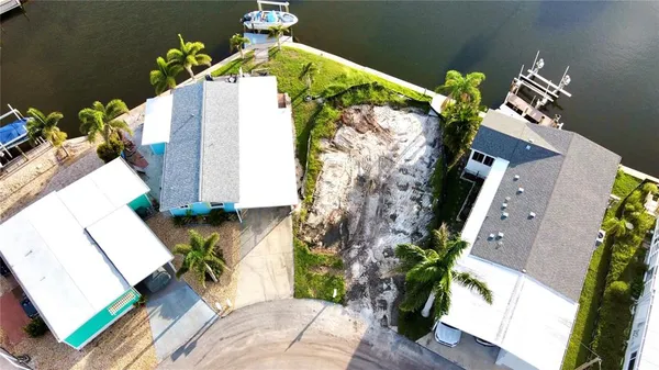 an aerial view of a house with a yard and wooden floor