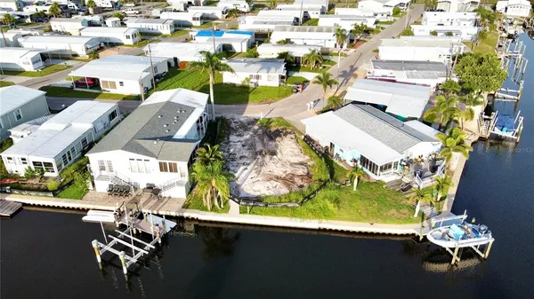 an aerial view of a residential houses with yard