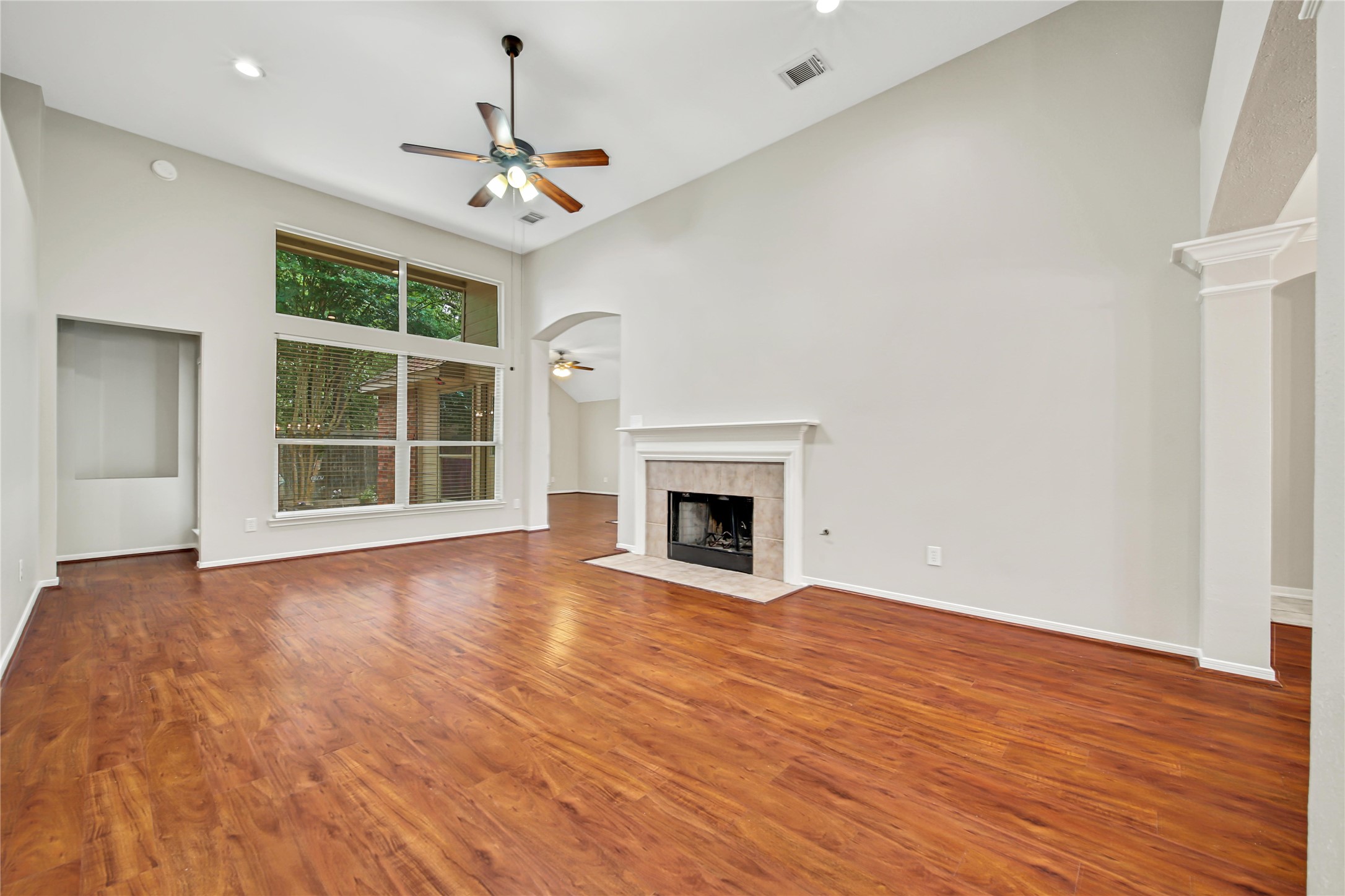 14526 Red Tailed Hawk Lane Houston, TX 77044 - Photo 5 of 40 a view of an empty room with wooden floor fireplace and a window