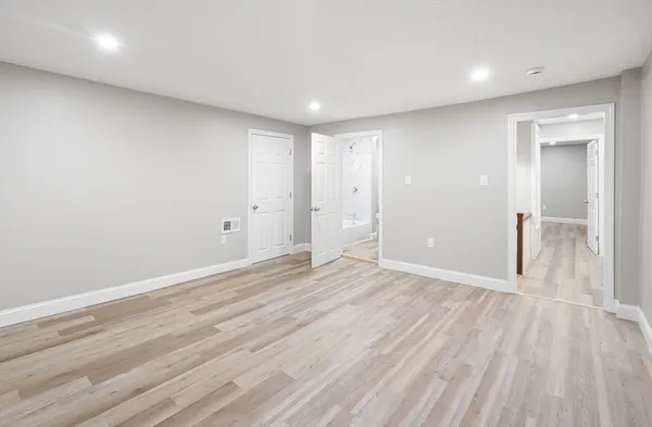 a view of an empty room with wooden floor