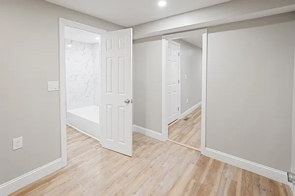 a view of an empty room with wooden floor