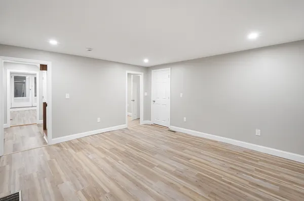 a view of an empty room with wooden floor