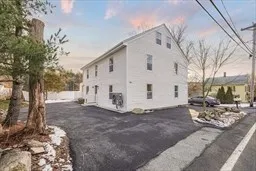 a view of a white house with a yard covered in snow