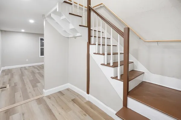 a view of entryway and hall with wooden floor