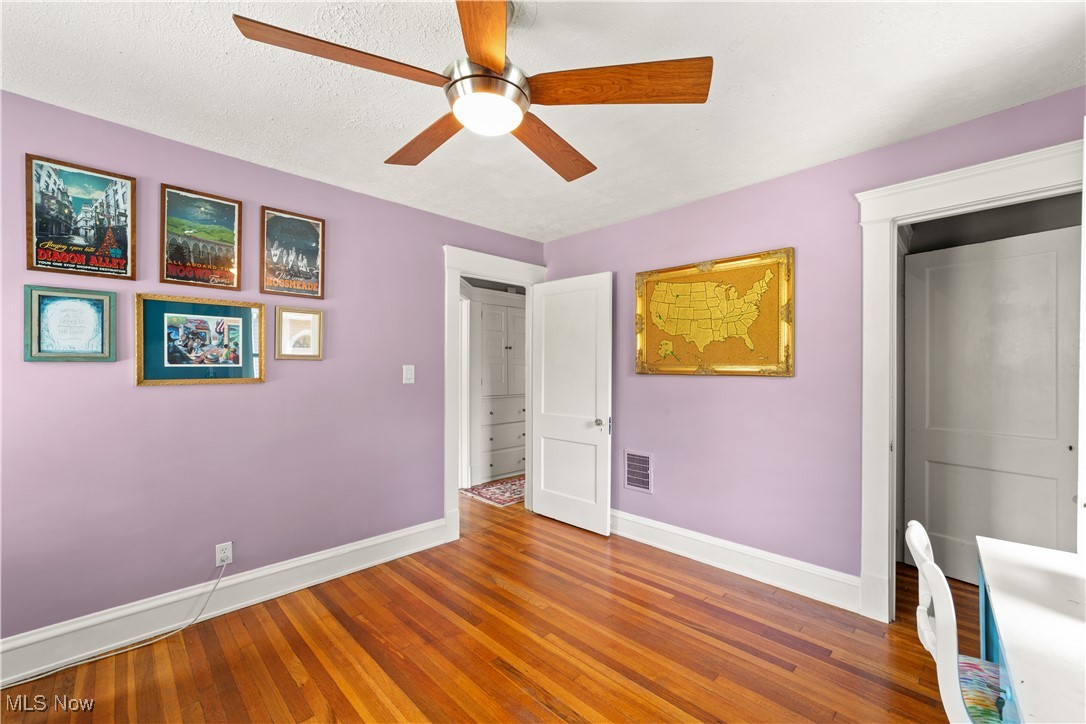 3024 Somerton Road Cleveland, OH 44118 - Photo 29 of 39 Unfurnished bedroom with wood-type flooring, ceiling fan, and a textured ceiling
