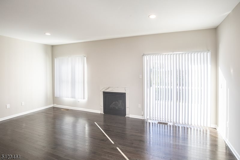 96 Arlene Court Morris Plains, NJ 07950 - Photo 13 of 24 an empty room with wooden floor and windows