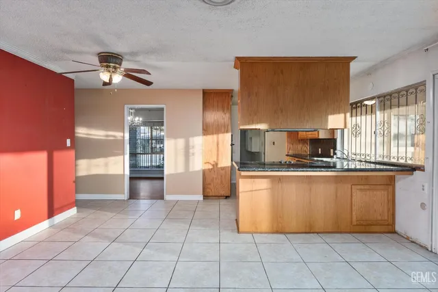 a large kitchen with stainless steel appliances granite countertop a refrigerator and a stove top oven