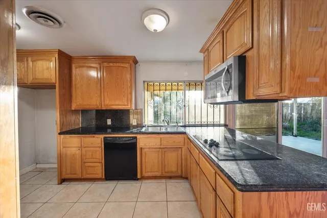 a kitchen with stainless steel appliances granite countertop a sink and cabinets