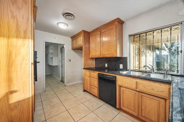 a large kitchen with a large window and stainless steel appliances