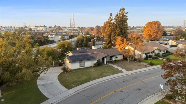 an aerial view of a house with a yard basket ball court and outdoor seating