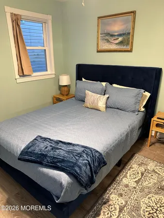 a bedroom with a bed and a painting on the wall