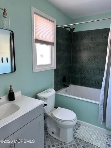 a bathroom with a toilet a sink and bathtub